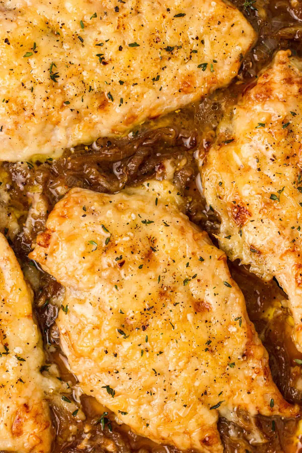 Up close photo of French Onion Soup Chicken in sauce. 