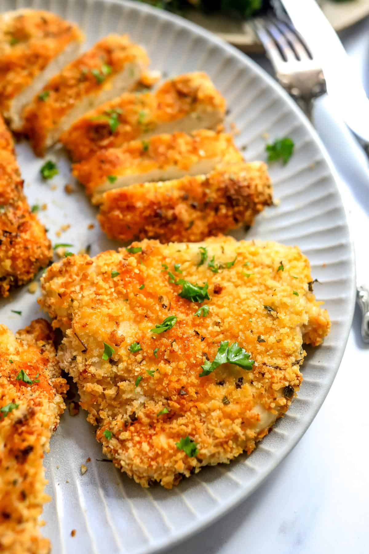 An overhead image of air fryer chicken cutlets on a plate.