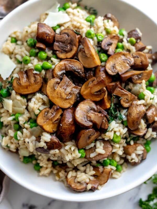 An overhead image of mushroom pea risotto in a bowl.