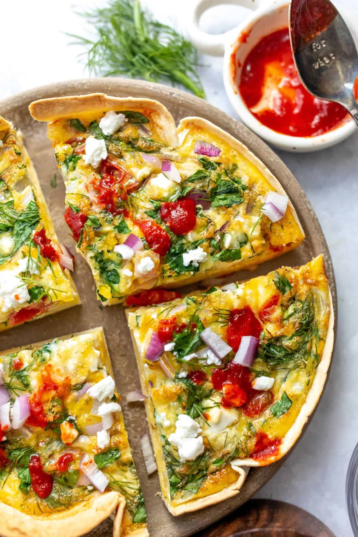 A close up image of tortilla quiche bake in slices of four.