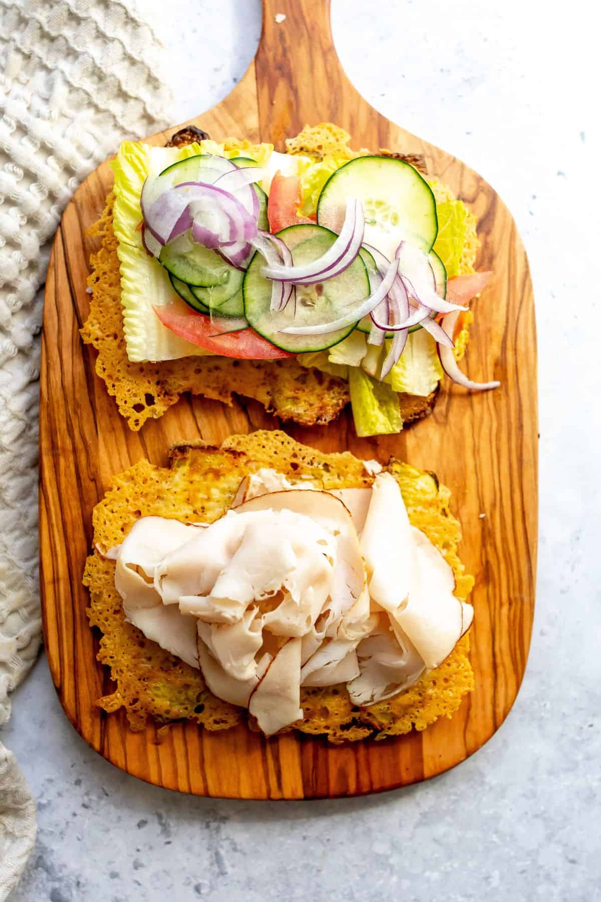 Low carb pickle wraps on a cutting board with turkey.