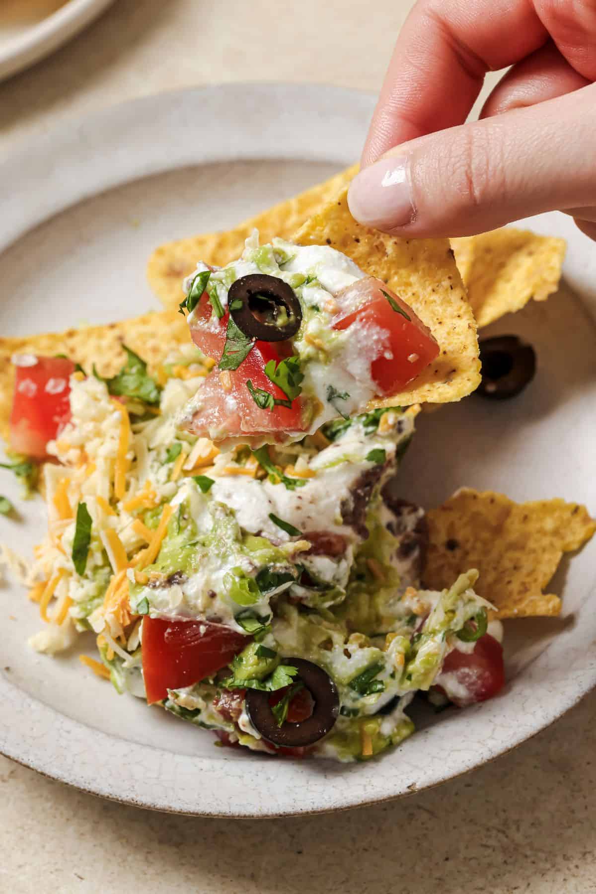 A close up image of the dip served with some nacho chips.