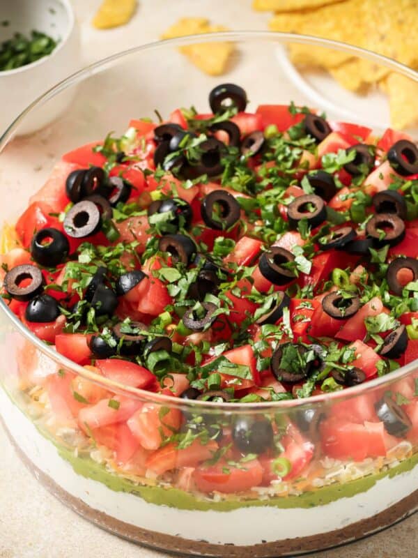 A close up image of 7 layer dip in a bowl.