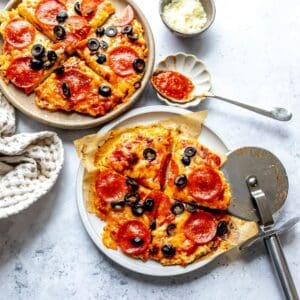 Chicken Pizza Crust on plates with a spoon to the side.