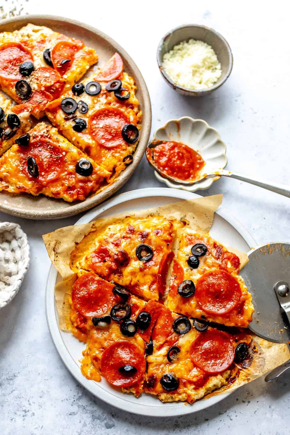 Chicken Pizza Crust on plates with a spoon to the side.