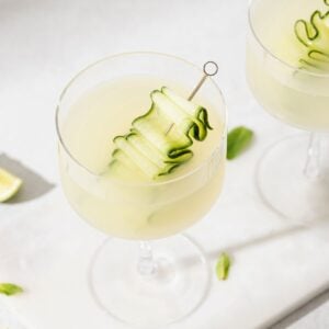 Refreshing cucumber martini cocktail in a stemmed glass, garnished with cucumber ribbons—an easy cucumber martini recipe perfect for summer.