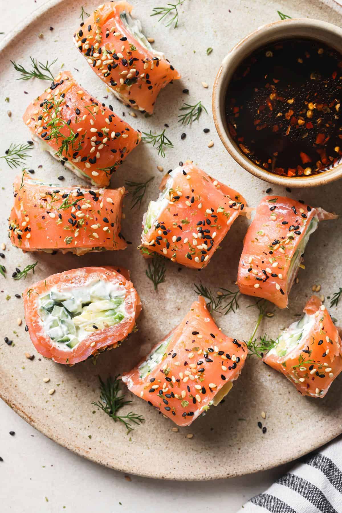 Salmon Avocado Rolls on a plate with sauce