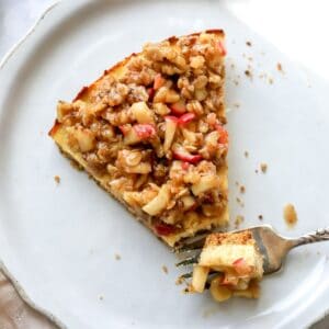 Cottage Cheese Cheesecake on a white plate with a fork on it.