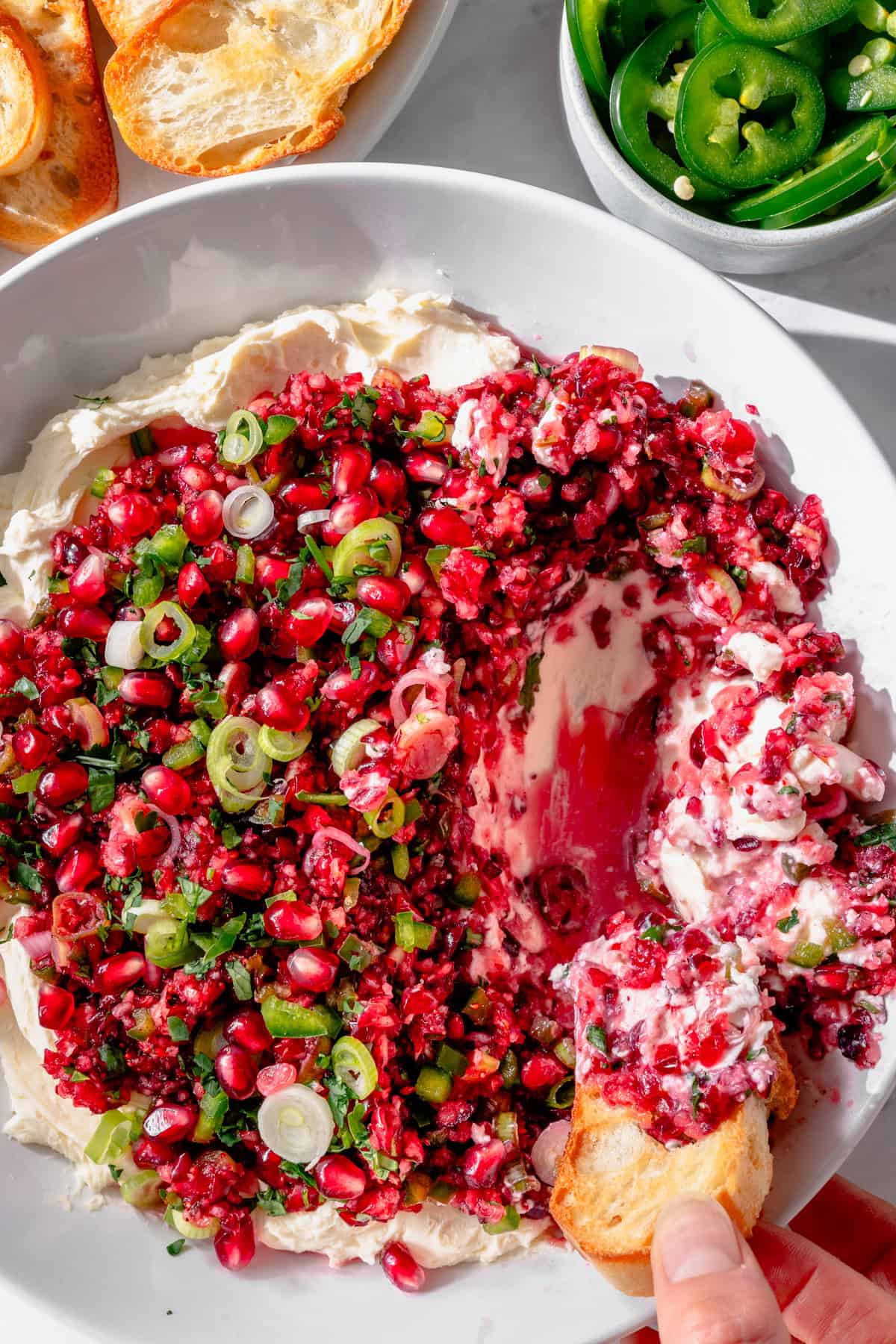Cranberry jalapeño cream cheese dip topped with vibrant cranberry mixture.