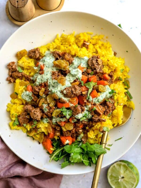 Golden Rice Bowls on a counter with a squeezed lime to the side.