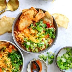 Buffalo Chicken Chili in ceramic bowls with tortilla chips in it.