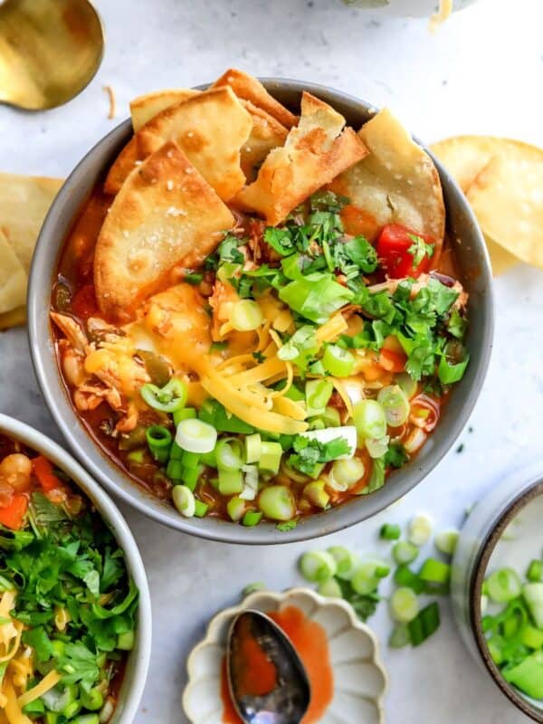 Buffalo Chicken Chili in ceramic bowls with tortilla chips in it.