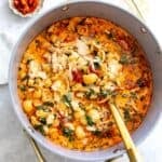 Grey bowl with Marry Me Chicken Soup in it and noodles off to the side.