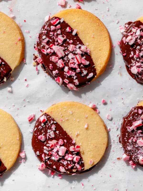 Peppermint Chocolate Dipped Shortbread on parchment paper in a row.