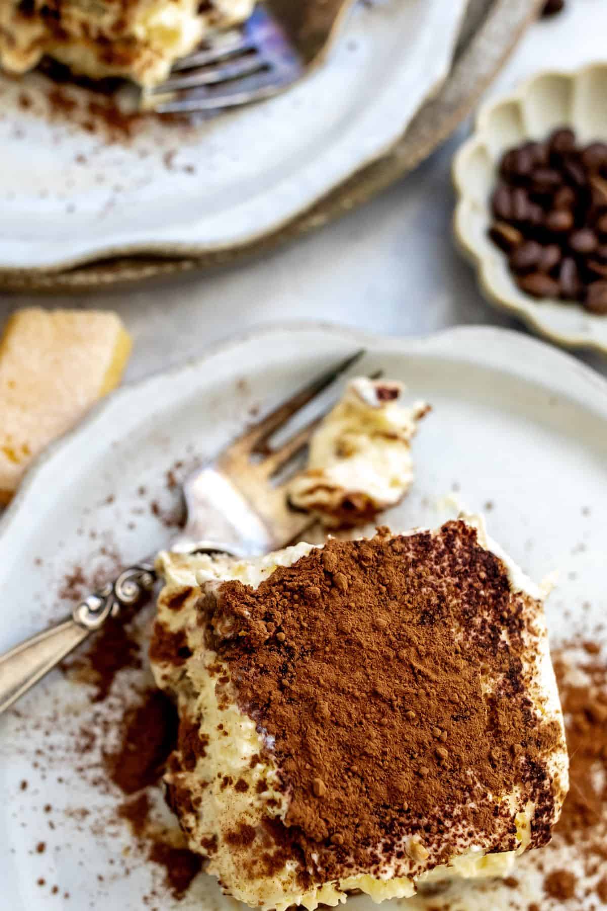 Tiramisu sliced in a baking dish with layers. 