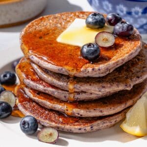 Protein Pancakes on a white plate with blueberries and cottager cheese.