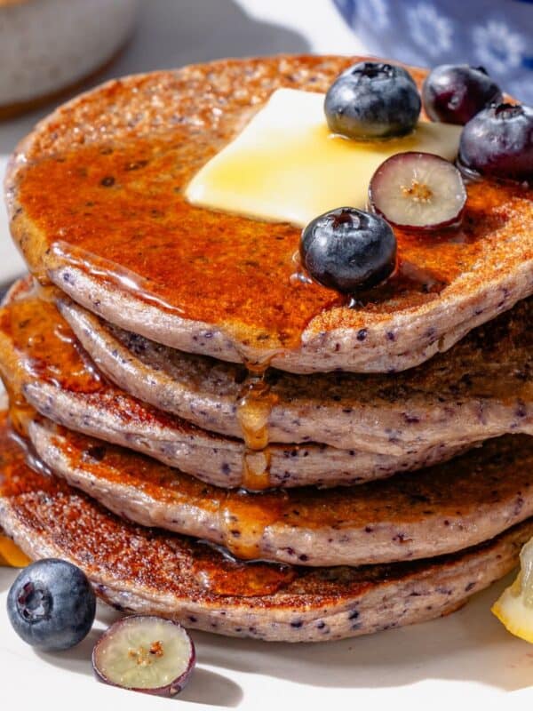 Protein Pancakes on a white plate with blueberries and cottager cheese.