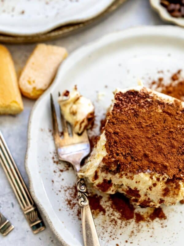 Tiramisu sliced in a baking dish with layers.