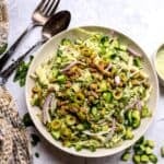 Green Goddess Salad recipe in a larger serving bowl with dressing to the side.