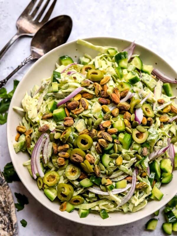 Green Goddess Salad recipe in a larger serving bowl with dressing to the side.