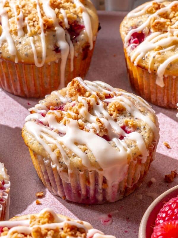 Fluffy lemon raspberry muffins with powdered sugar glaze