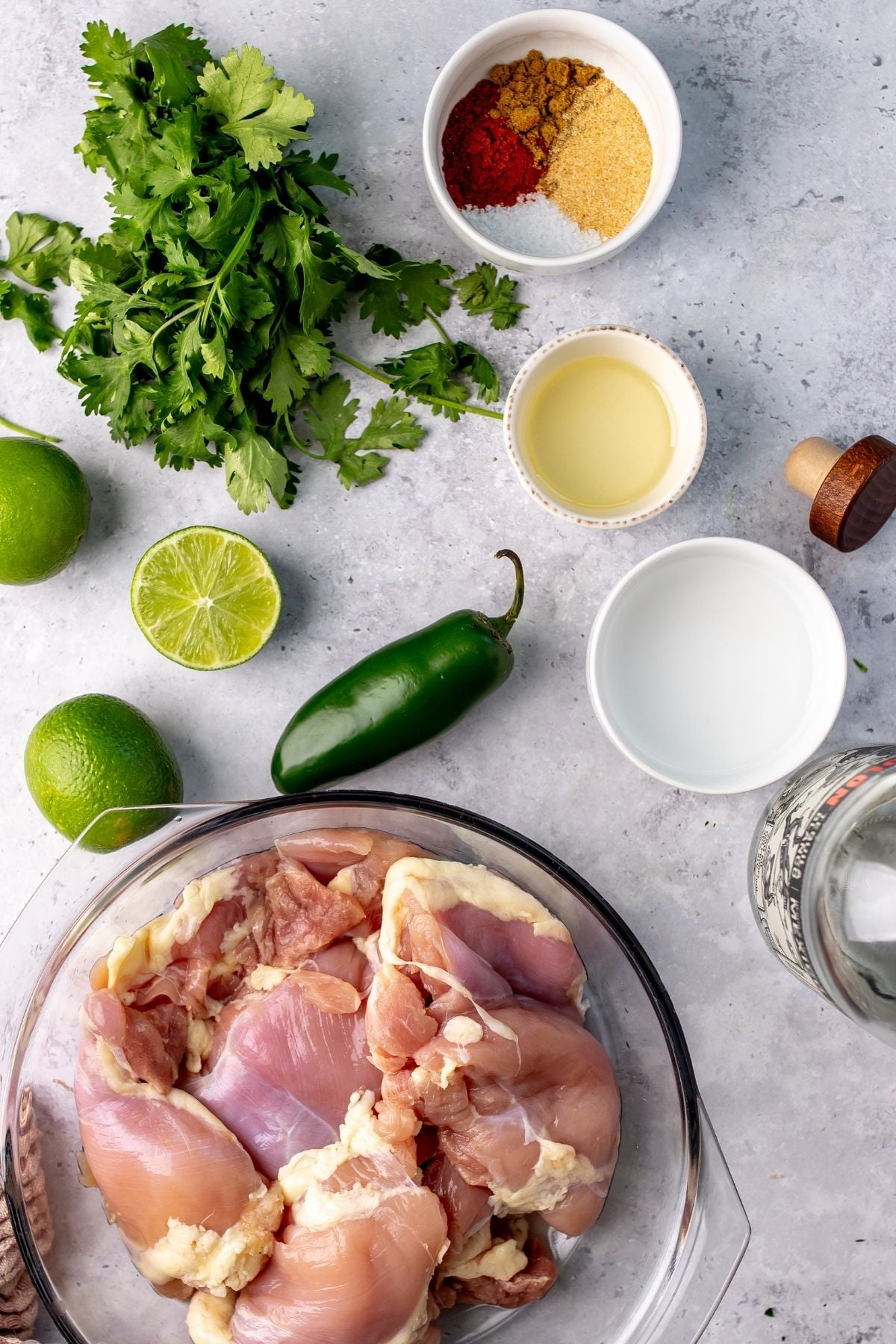 Chicken and veggies on a counter top lined up neatly.