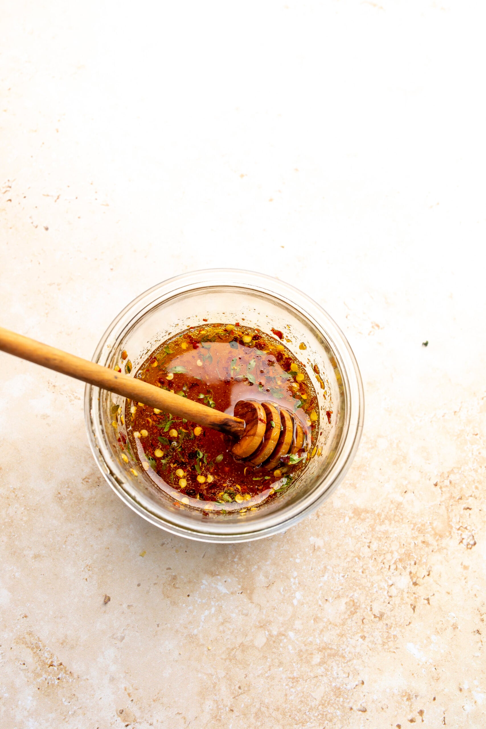 Hot honey in a small jar with a honey stick.