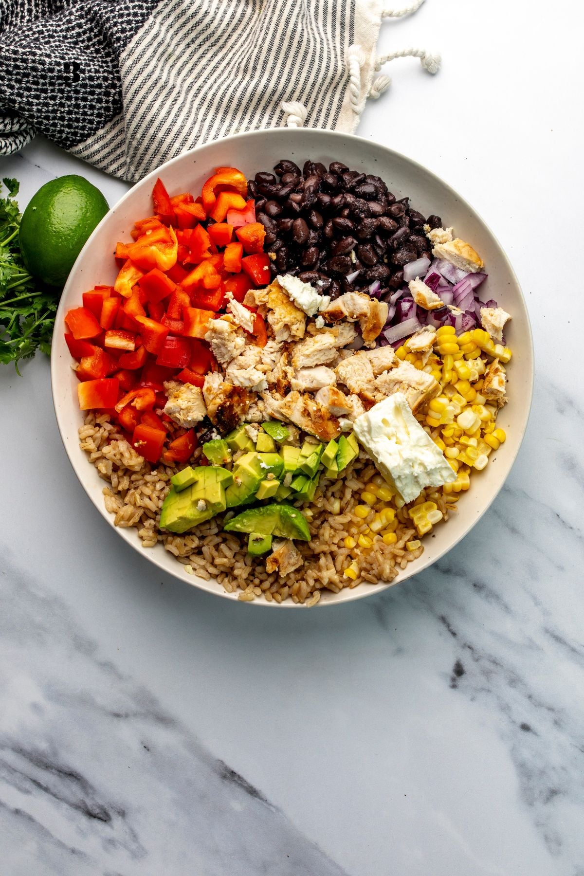 White bowl with fresh ingredients in it sorted out neatly before mixing.