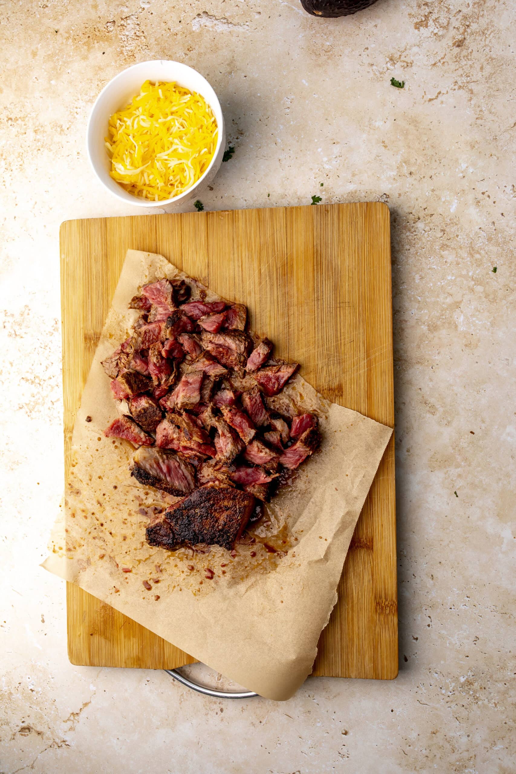 The cooked steak sliced on a wooden cutting board.