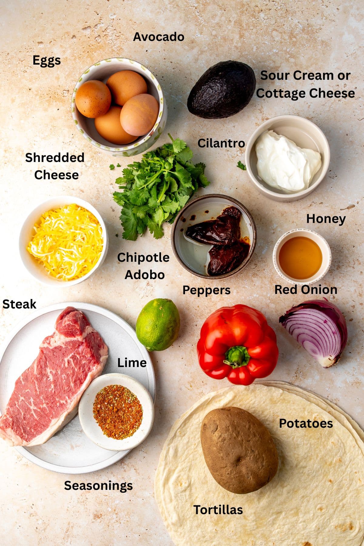 All of the ingredients for steak breakfast burritos in bowls on a countertop.