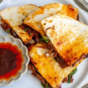 Birria quesadilla on a white plate for serving.