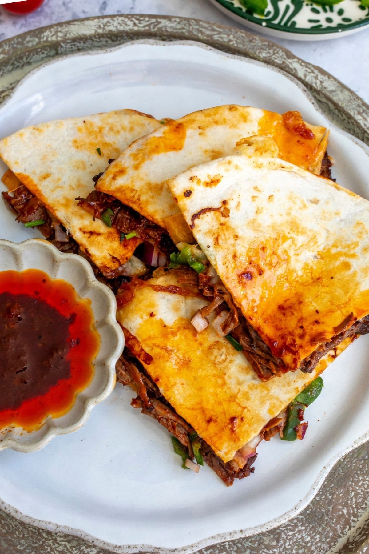Birria quesadilla on a white plate for serving.