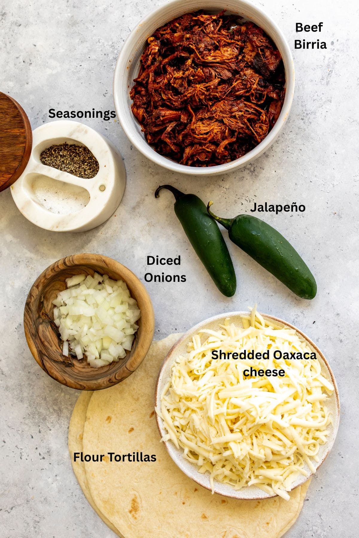 All of the ingredients for birria quesadillas on a countertop.