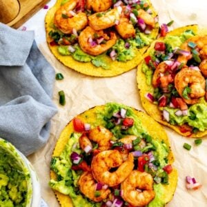 Shrimp tostadas on a piece of parchment paper for serving.