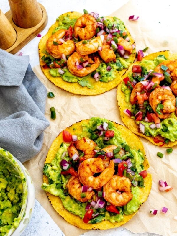Shrimp tostadas on a piece of parchment paper for serving.