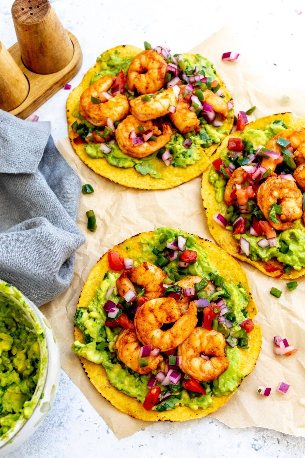 Shrimp tostadas on a piece of parchment paper for serving.