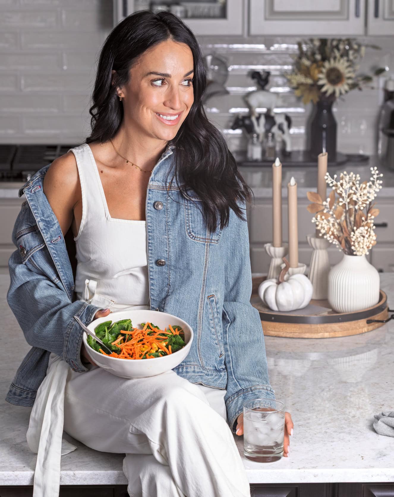 Bailey holding a bowl recipe from the book in her hands on a countertop.