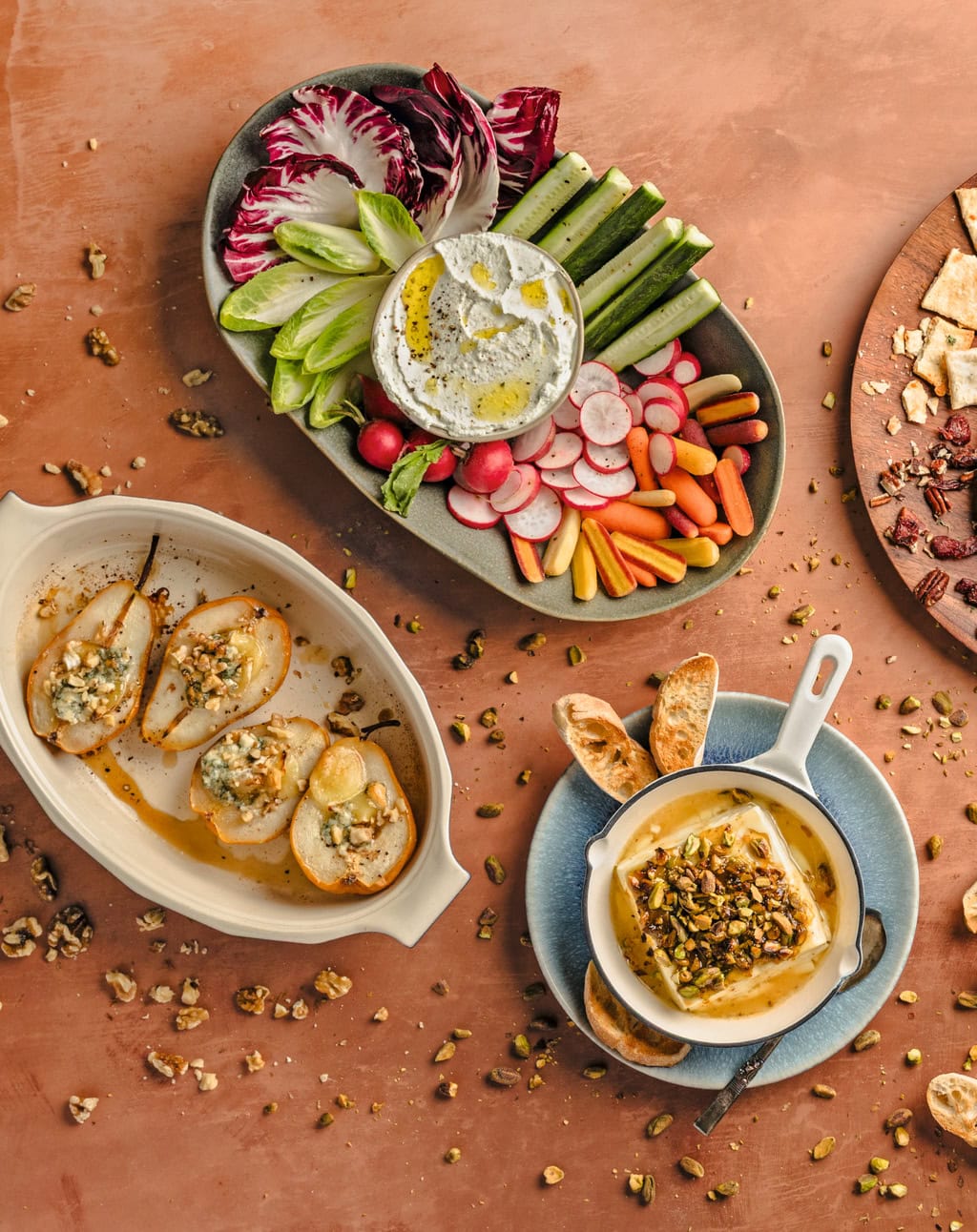 Multiple recipes from the cheese chapter of the cookbook on a countertop.